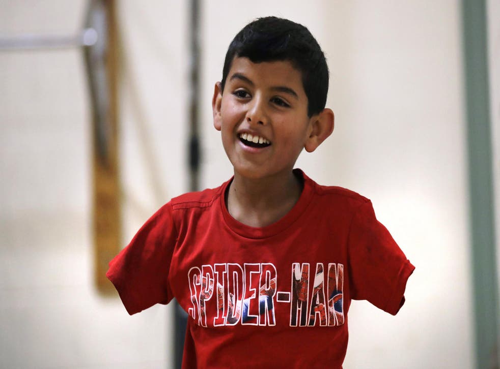'Anything is possible in this world. You just have to believe in yourself,' says Ahmad, 11, whose arms were blown off above the elbows in a bomb blast at a refugee camp in Syria that killed three of his siblings in 2014