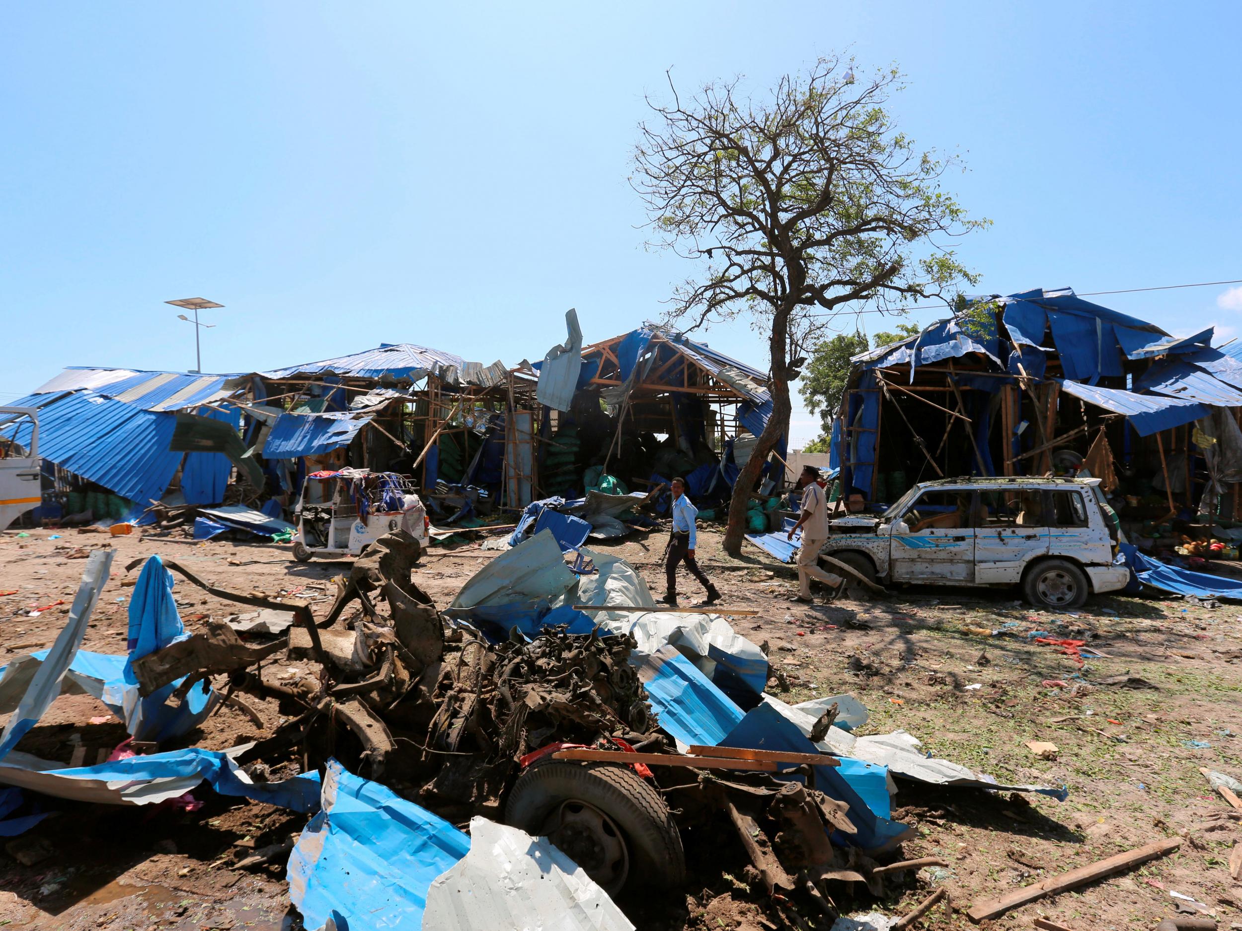 Somalia's capital has seen frequent bomb attacks at hotels and military checkpoints, threatening attempts to rebuild from decades of chaos. In this photo, a Somali policeman walks near destroyed cars at a police checkpoint near a vegetable market.