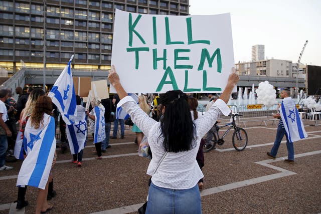 A supporter of Elor Azaria, an Israeli soldier charged with manslaughter by the Israeli military after he shot a wounded Palestinian assailant as he lay on the ground holds a placard during a protest calling for his release