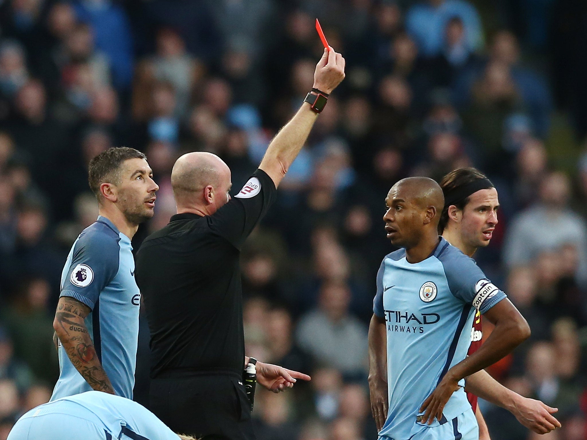 Fernandinho is shown red for his challenge on Johann Gudmundsson