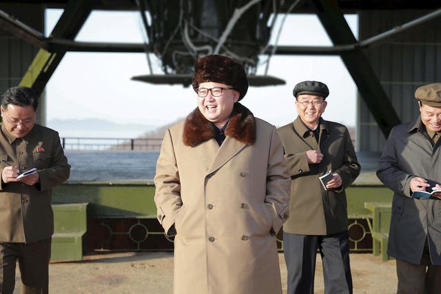 North Korea leader Kim Jong Un smiles as he visits Sohae Space Center for the testing of a new engine for an intercontinental ballistic missile
