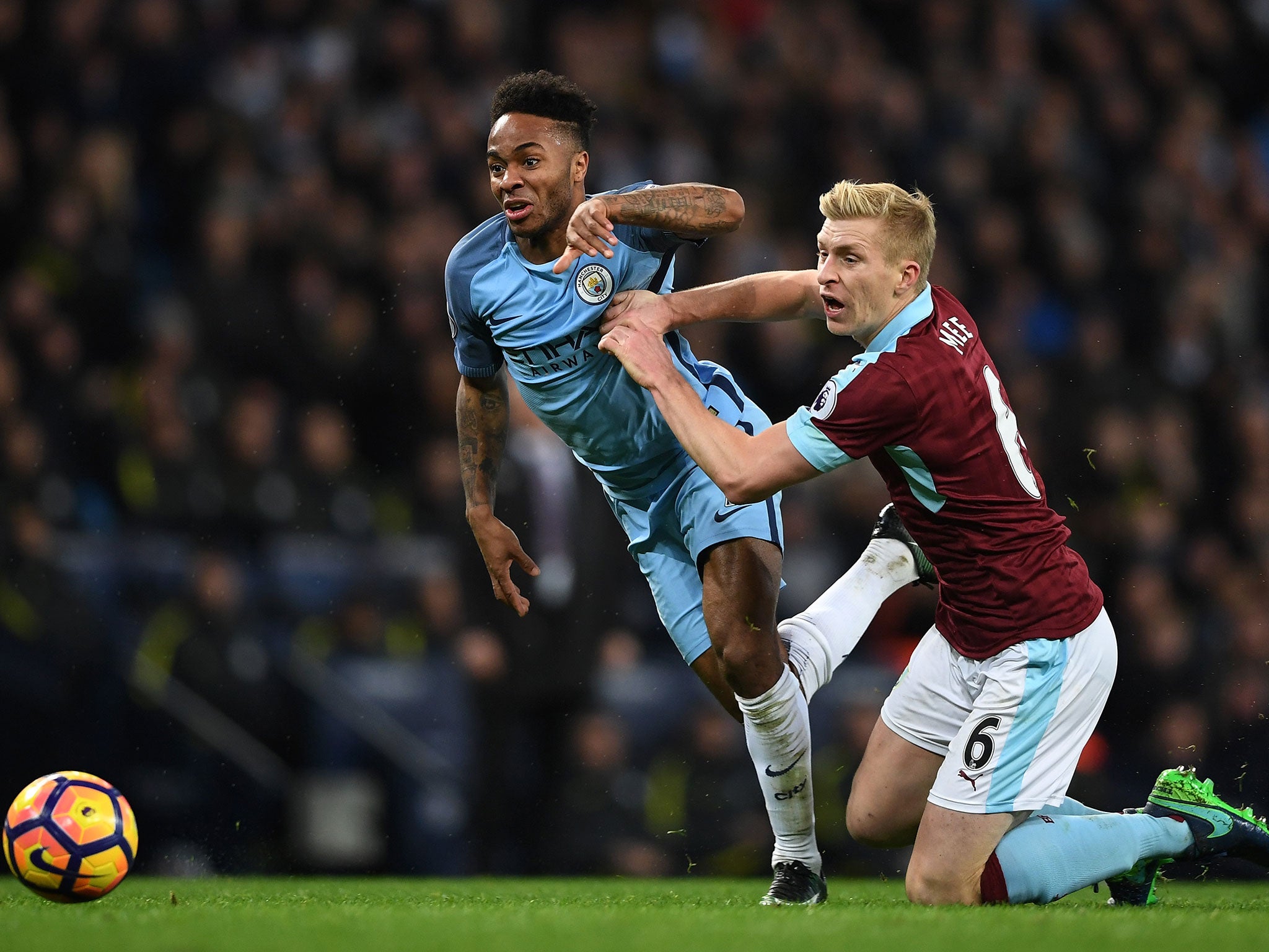 Raheem Sterling attempts to get away from Ben Mee