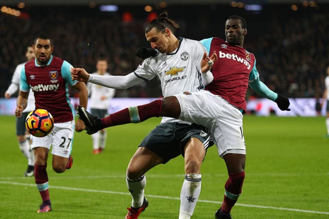 Pedro Obiang and Zlatan Ibrahimovic wrestle for the ball