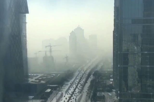 The video shows the smog completely engulfing the city's buildings