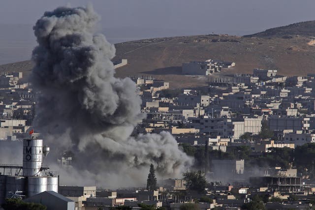 Smoke rises following an air strike by the US-led coalition in Kobani, Syria, during fighting between Kurds and Isis in October 2014