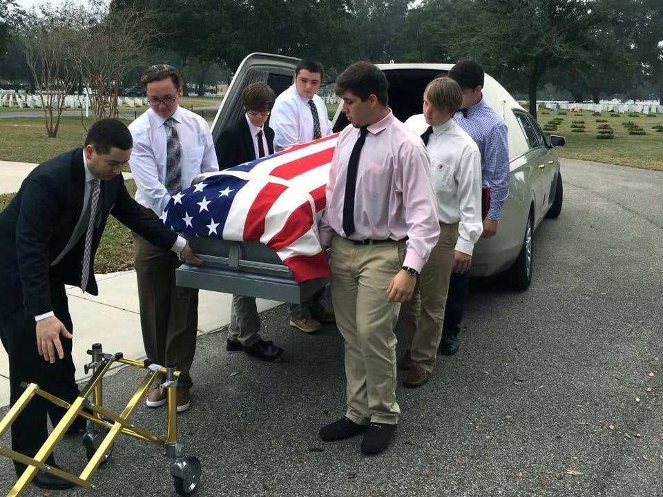 The six teenagers take Mr Pino's casket out of the hearse