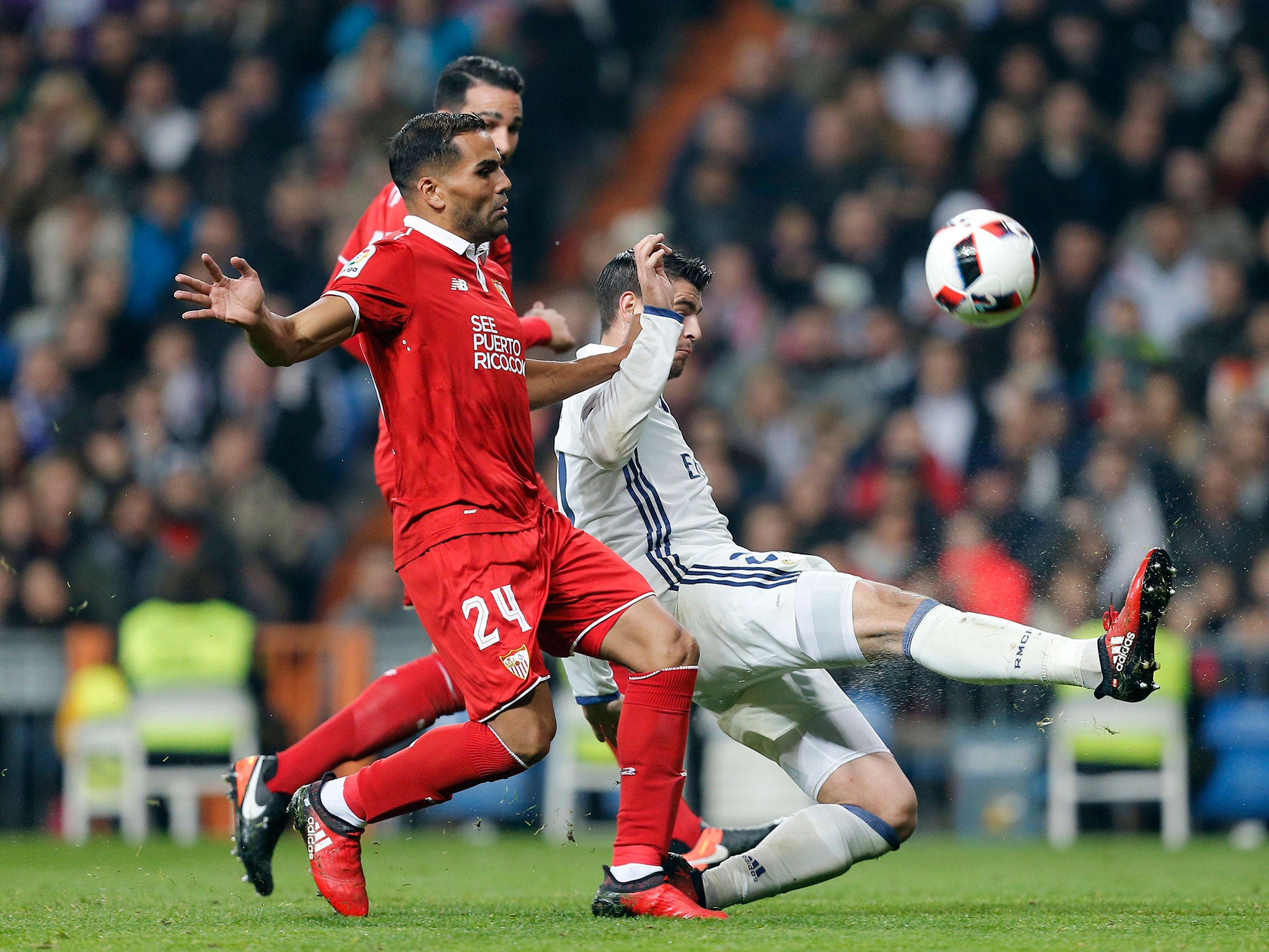 Morata duels for the ball with Sevilla's Mercado