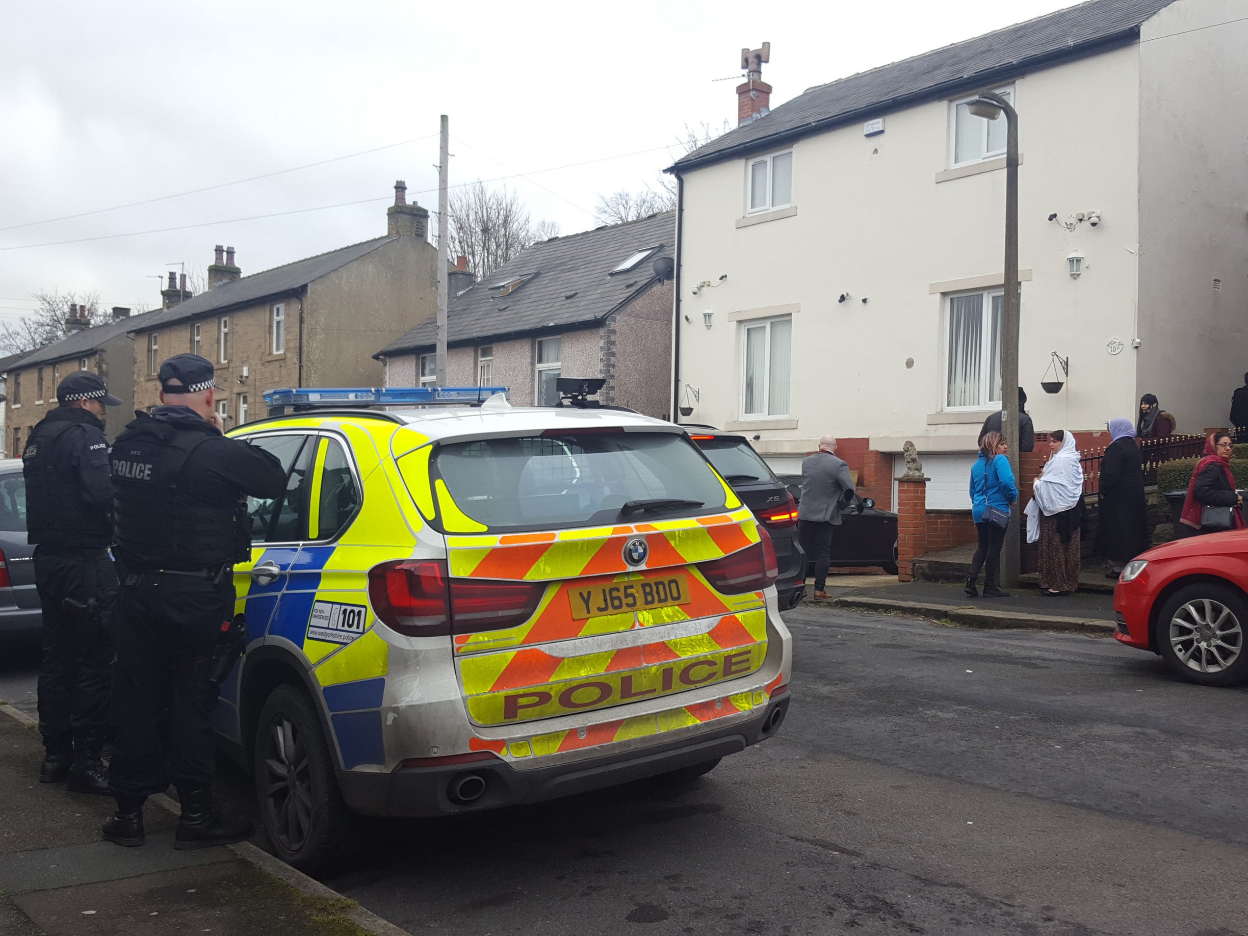 Armed police officers outside Mohammed Yassar Yaqub's home in the Crosland Moor area of Huddersfield PA