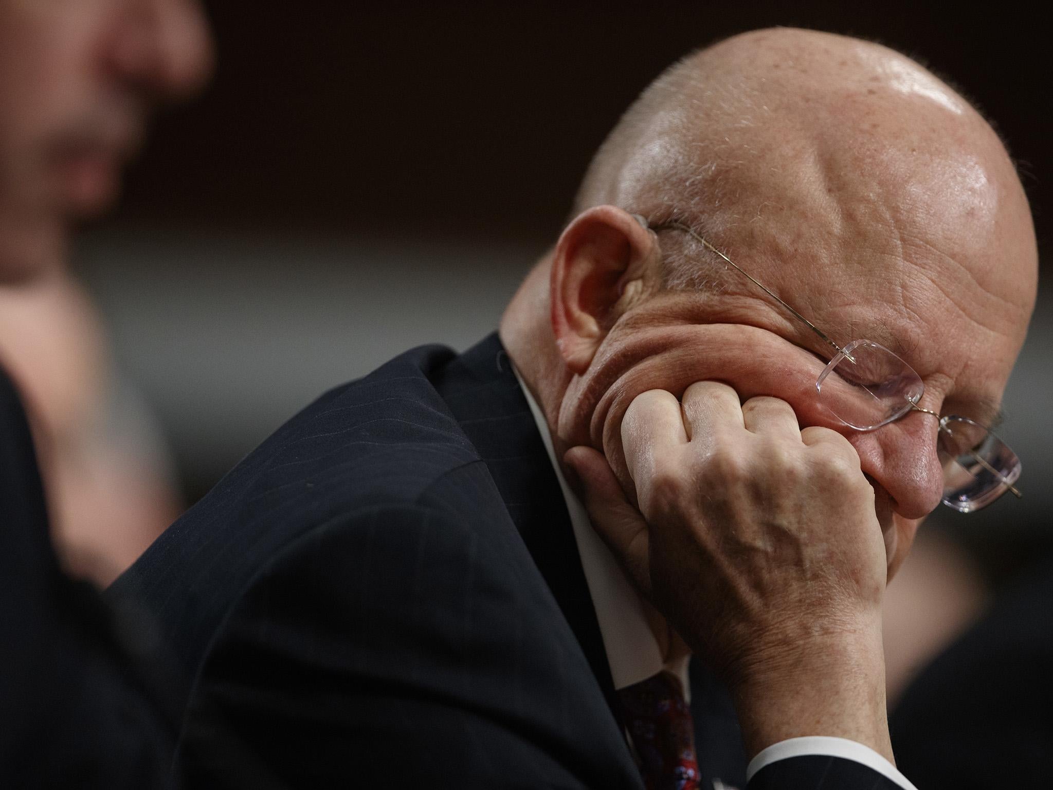 James Clapper listens to questions on Capitol Hill, while testifying before the Senate Armed Services Committee hearing