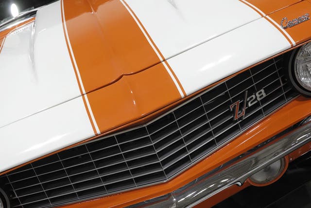 1969 Chevrolet Camaro Z28 retro sports car with white stripes over orange body