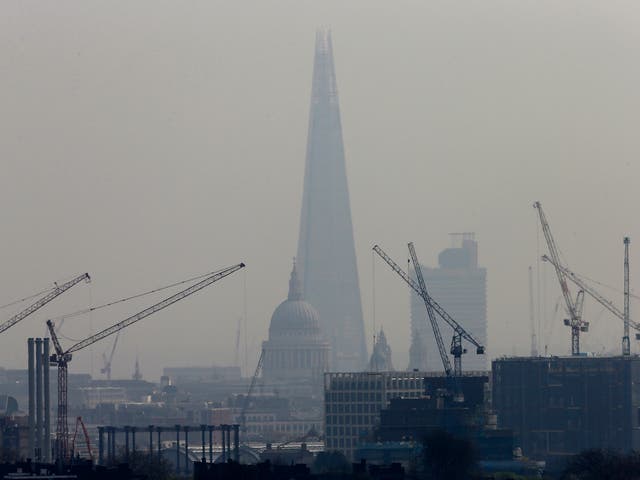 Smog surrounds The Shard, western Europe's tallest building, and St Paul's Cathedral in London