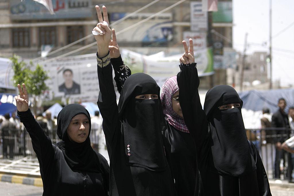 Female anti-government protesters flash the V-sign for victory during a demonstration demanding the resignation of Yemeni President Ali Abdullah Saleh in Sanaa on May 14, 2011