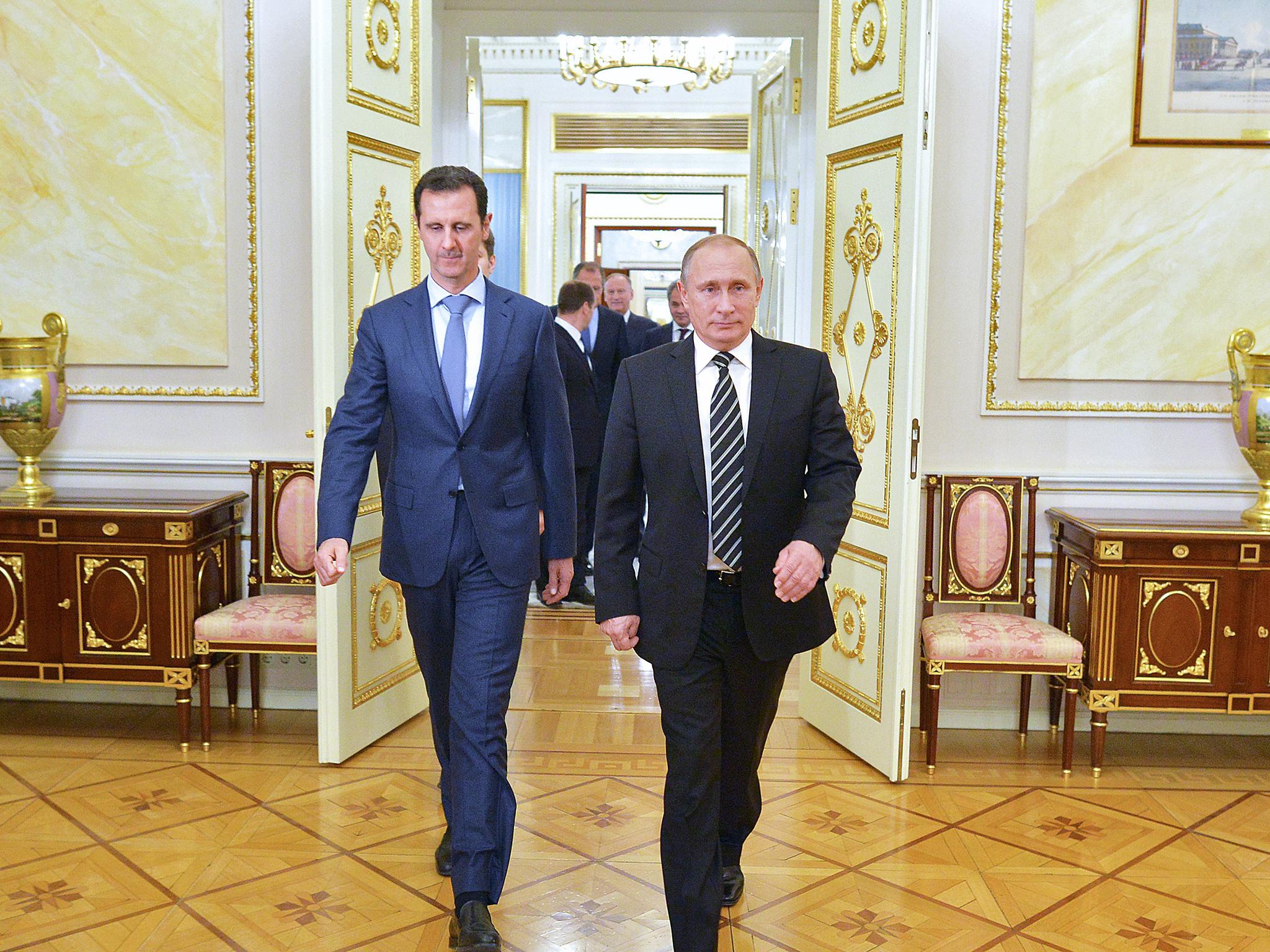 Russian President Vladimir Putin greets his Syrian counterpart Bashar al-Assad upon his arrival for a meeting at the Kremlin in Moscow