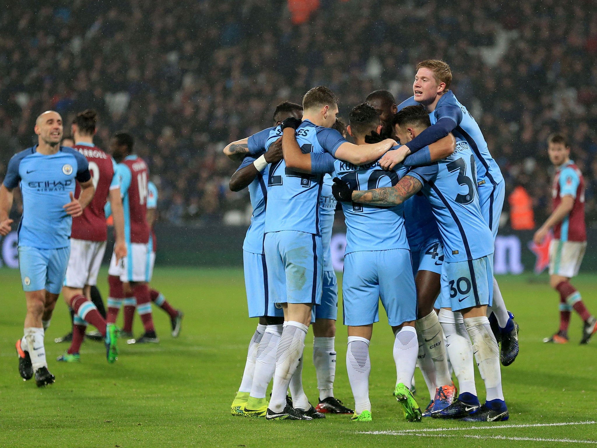 Manchester City's players celebrate their fourth goal at the London Stadium