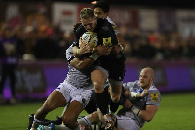 Alex Tait of Newcastle Falcons is brought down by Anthony Watson of Bath