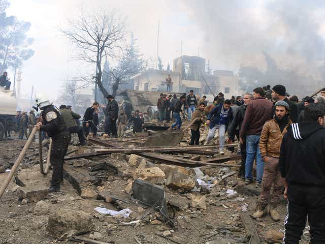 Rescue workers at the scene of a car bombing in the rebel-held Syrian city of Azaz along the Turkish border, on 7 January