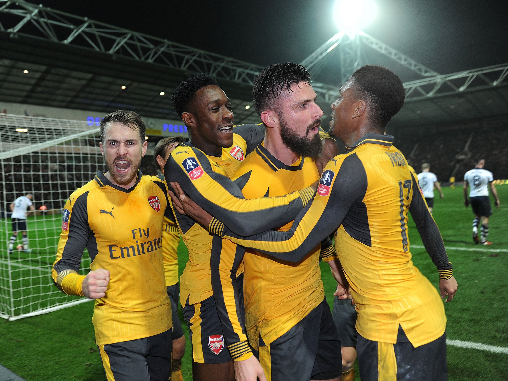 Arsenal's players celebrate their late winner at Deepdale