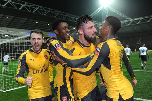 Arsenal's players celebrate their late winner at Deepdale