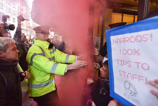 Protesters let off a smoke bomb outside Harrods department store in Knightsbridge