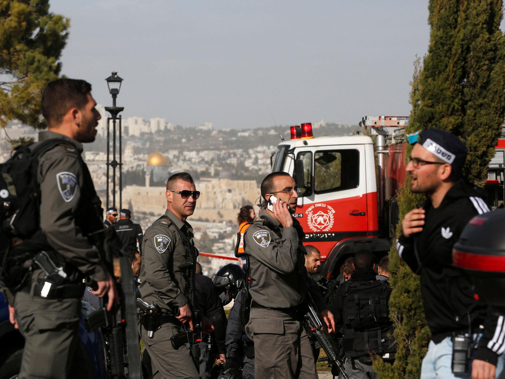 Israeli security forces at the scene of Sunday's attack which killed four young recruits and left 13 more injured