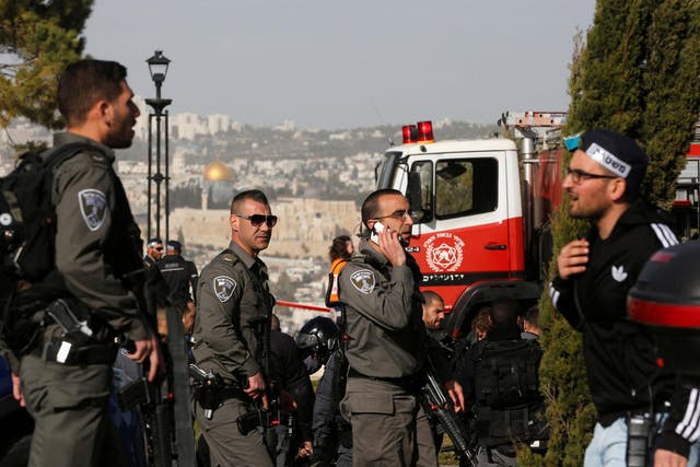 Israeli security forces at the scene of Sunday's attack which killed four young recruits and left 13 more injured 