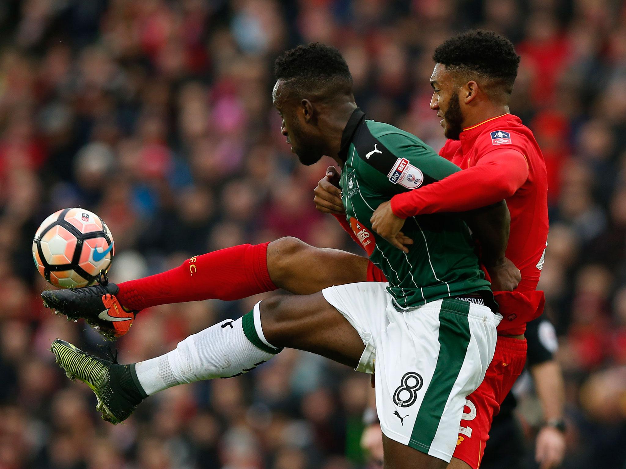 Joe Gomez tussles for the ball with Jordan Slew (Getty)