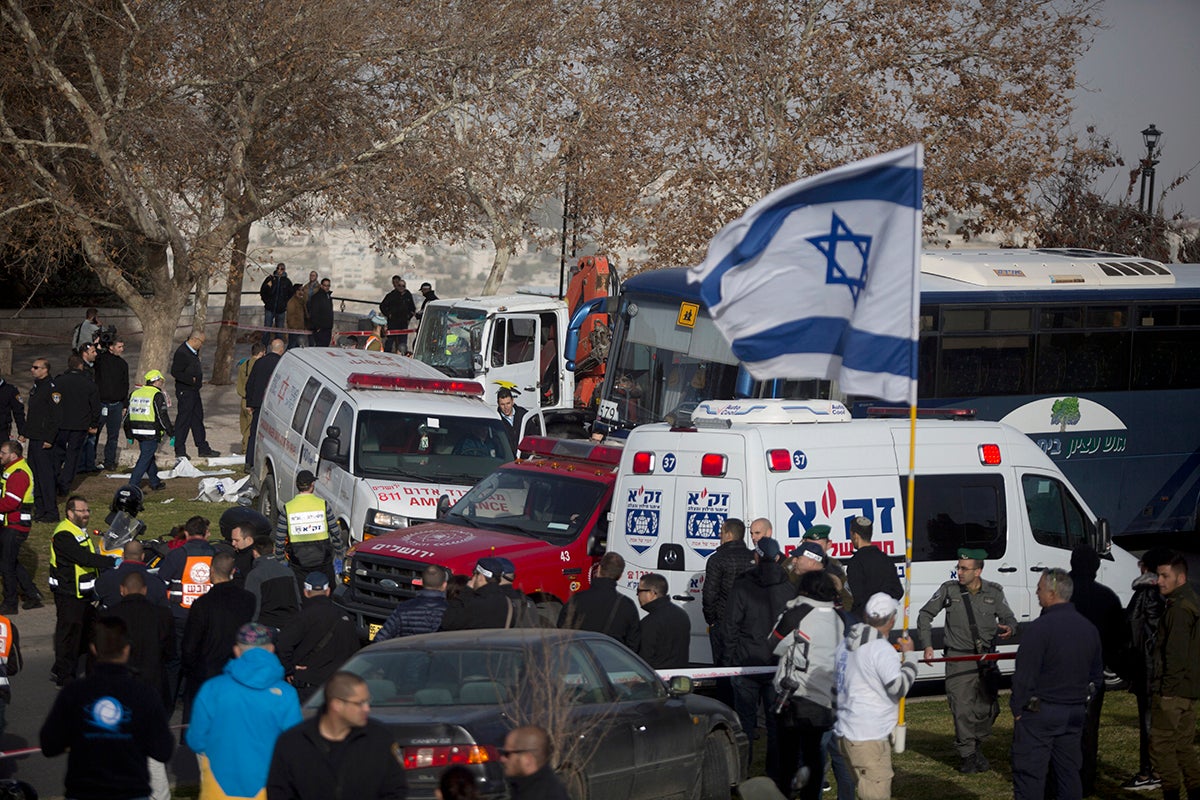 Israeli security forces and emergency services gather at the site of a vehicle-ramming attack on 8 January in Jerusalem. Four israeli soldiers were killed and 13 wounded in the attack