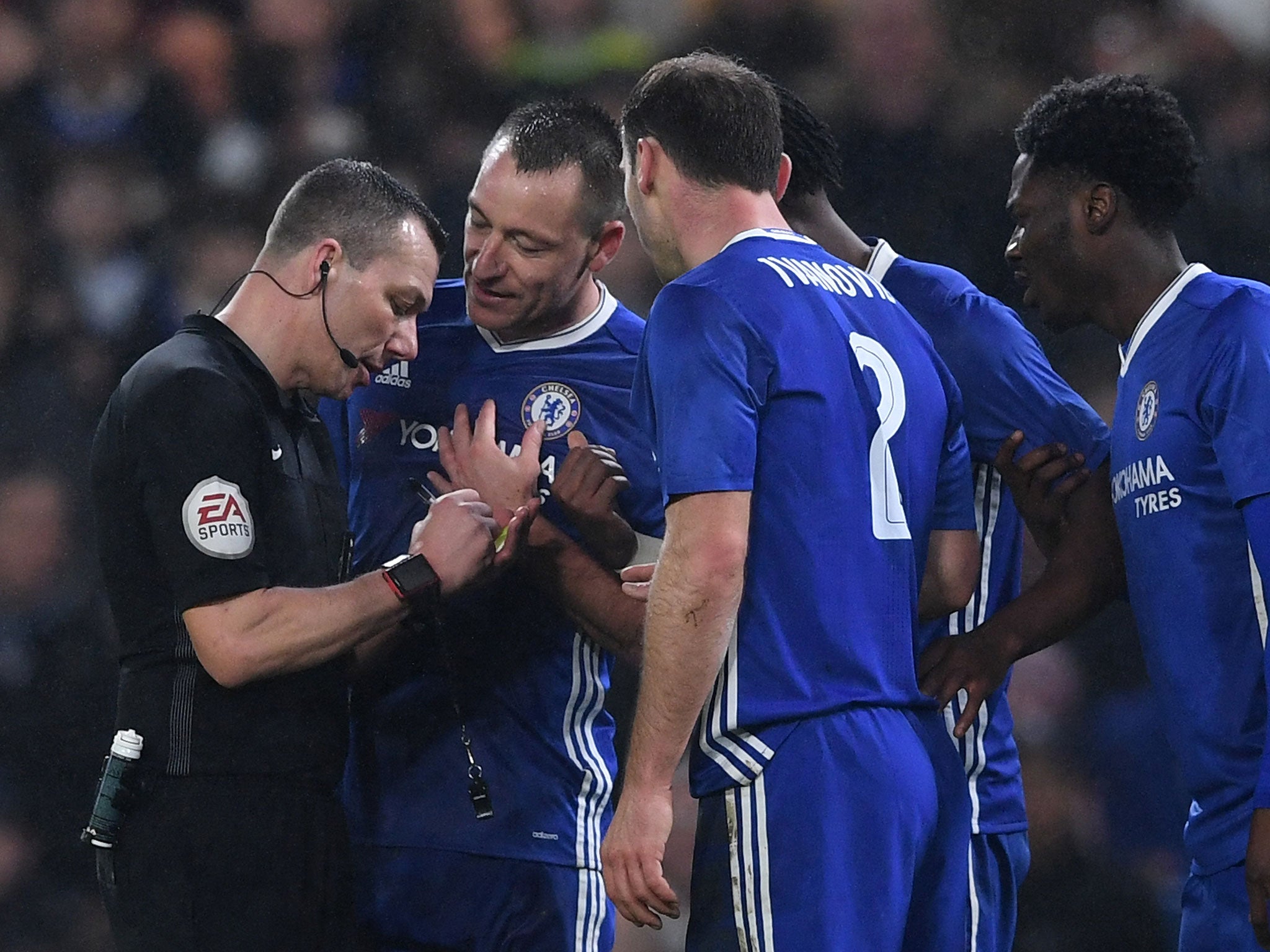John Terry argues with referee Kevin Friend after being shown red