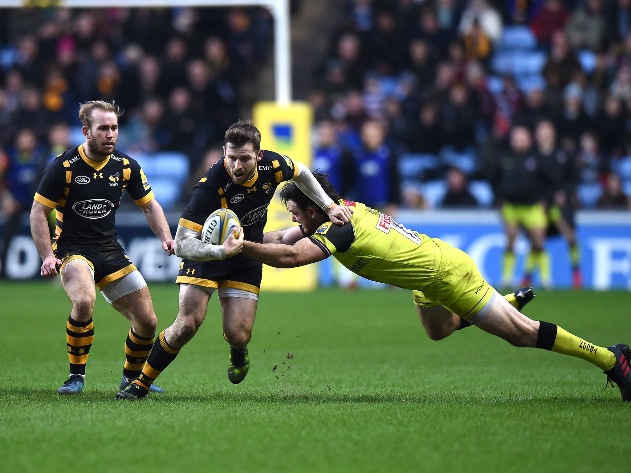 Elliot Daly is tackled by Leicester's Matt Smith