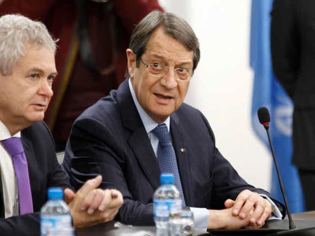 Greek Cypriot President Nicos Anastasiades, right, waits for the start of a new round of Cyprus peace talks