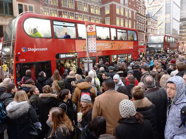 People queue for buses at Bishopsgate in the City of London, as Underground workers in the capital continued a 24-hour strike