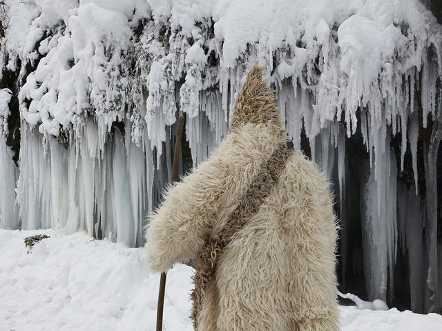 A man passes by a frozen waterfall at around minus 26 degrees Celsius (minus 14.8 degrees Fahrenheit) in the village of Jezerc, Kosovo