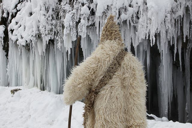 A man passes by a frozen waterfall at around minus 26 degrees Celsius (minus 14.8 degrees Fahrenheit) in the village of Jezerc, Kosovo