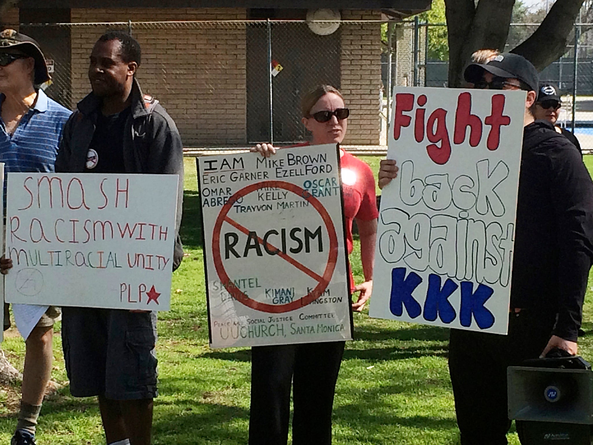 Counter protesters hold placards near a planned Klu Klux Klan rally in Anaheim, California