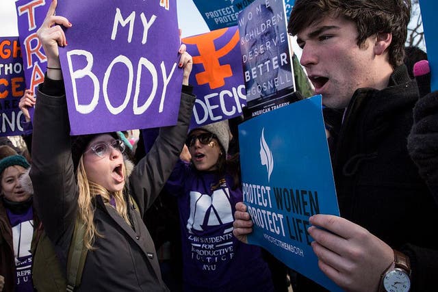 Pro-choice advocates (left) and anti-abortion advocates (right) rally outside of the Supreme Court, March 2, 2016 in Washington, DC.