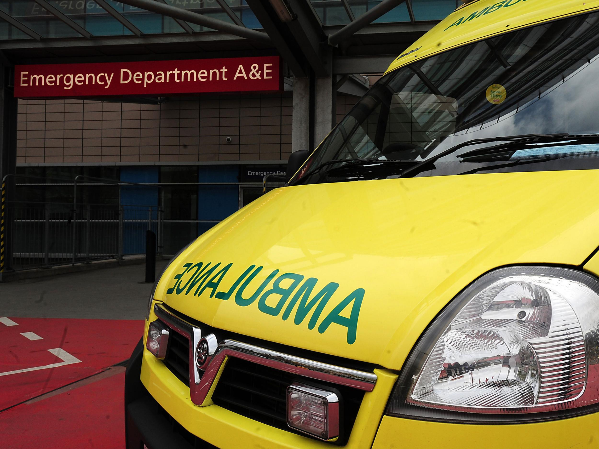 An ambulance outside an entrance to a hospital Accident and Emergency department