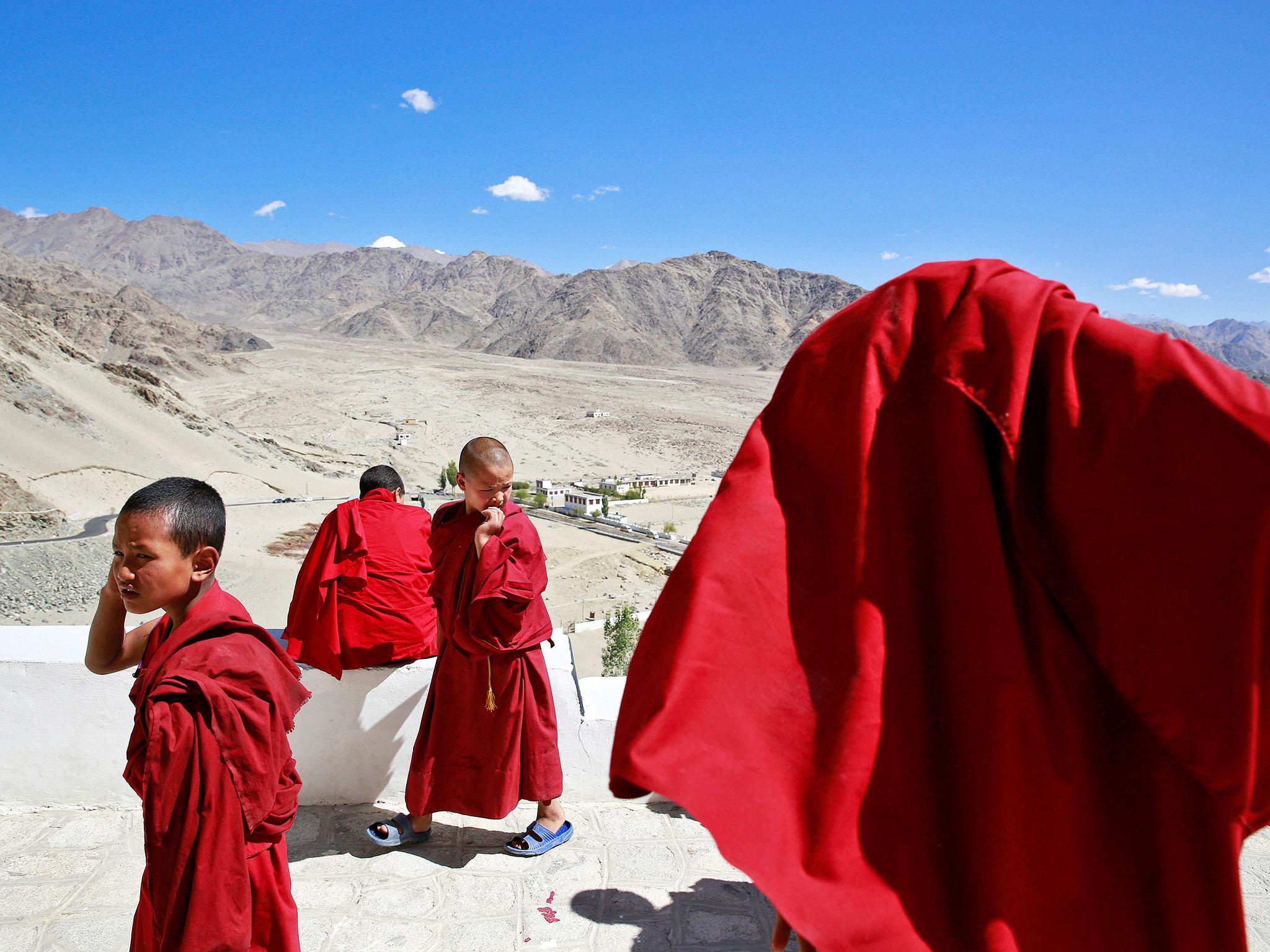 Young monks take a break from their studies inside Thiksey Monastery in Ladakh, India (Reuters)