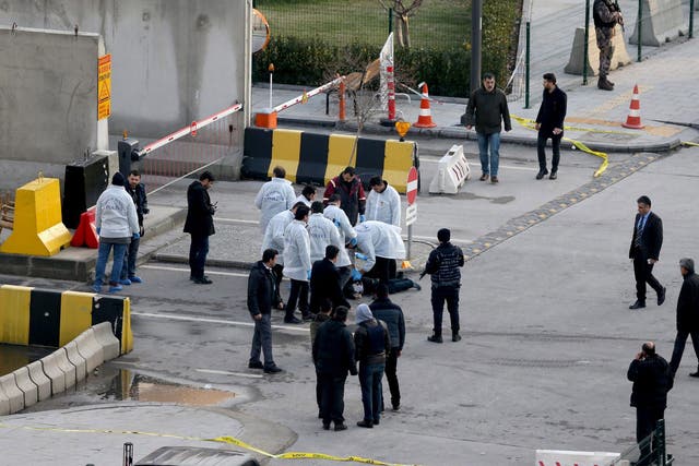 Investigators surrounding the body of a suspected attacker shot dead in front of Gaziantep police station, Turkey, on 10 January 2017