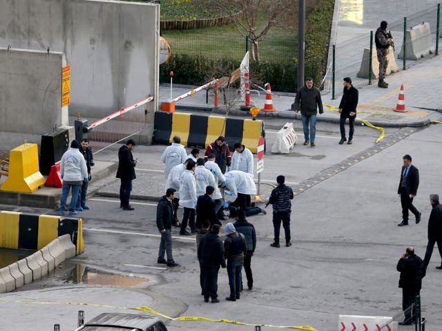 Investigators surrounding the body of a suspected attacker shot dead in front of Gaziantep police station, Turkey, on 10 January 2017