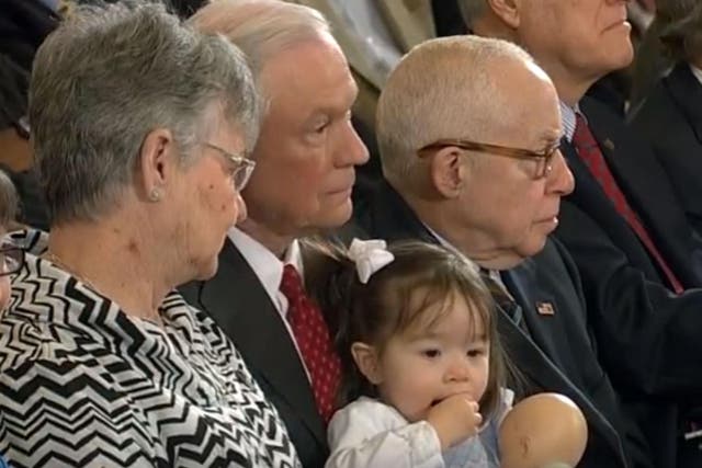 Mr Sessions held the child during the opening statements from his colleagues