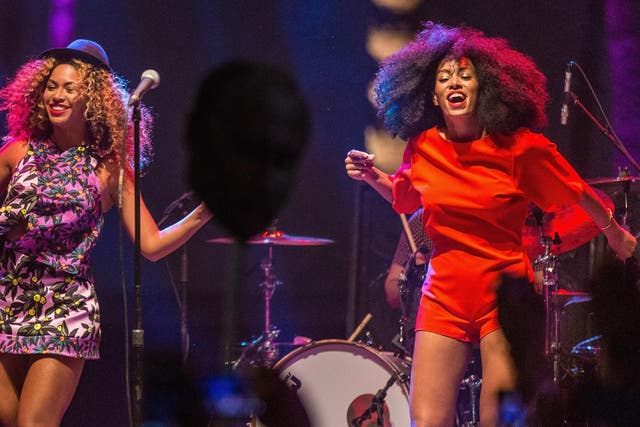 Singer Beyonce (L) performs with her sister Solange onstage during day 2 of the 2014 Coachella Valley Music & Arts Festival at the Empire Polo Club on April 12, 2014 in Indio, California.