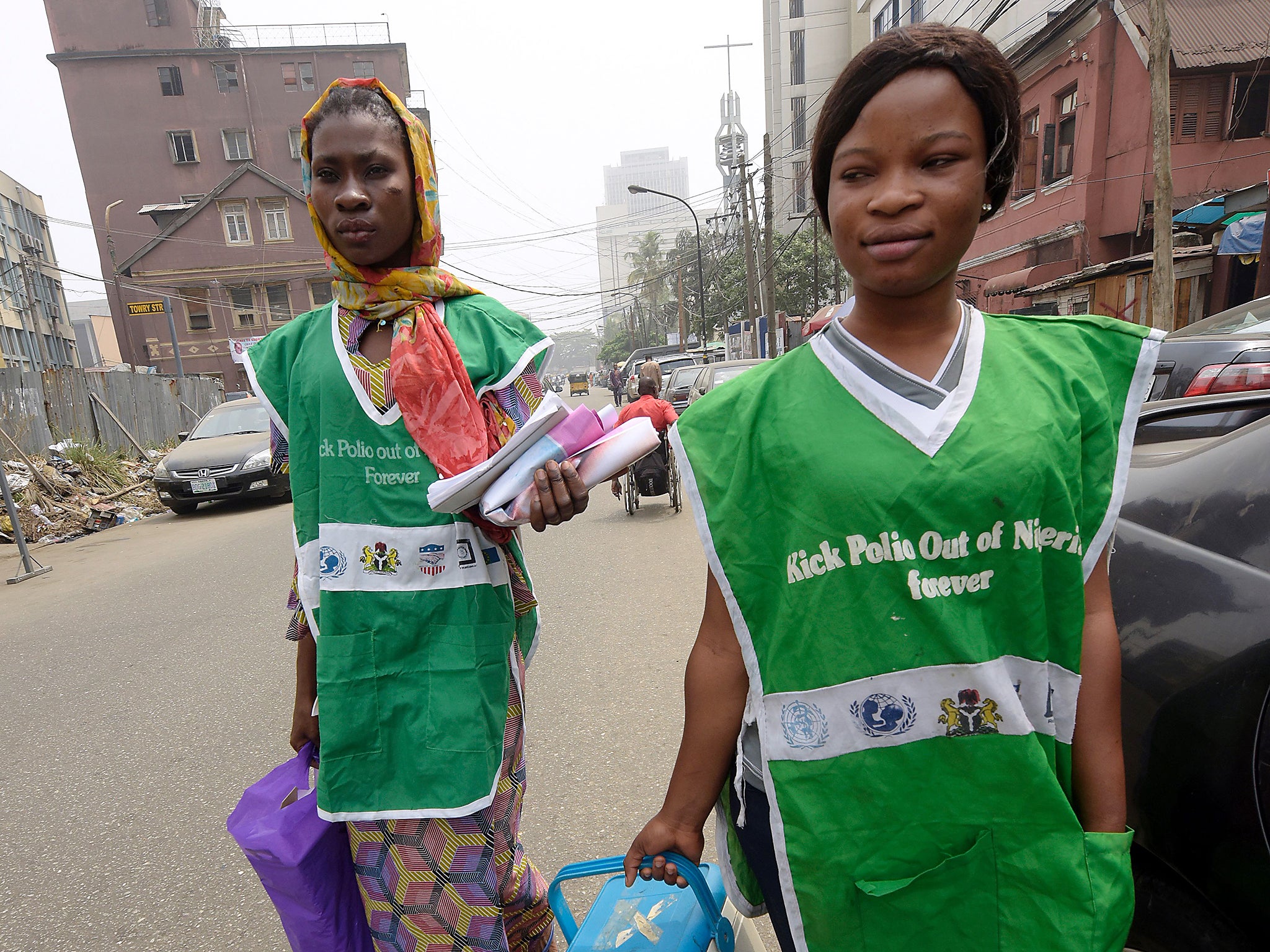 Health workers walk the streets to immunise children against polio and measles in Lagos