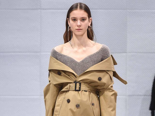 At Balenciaga the trench was worn off the shoulder and cinched at the waist