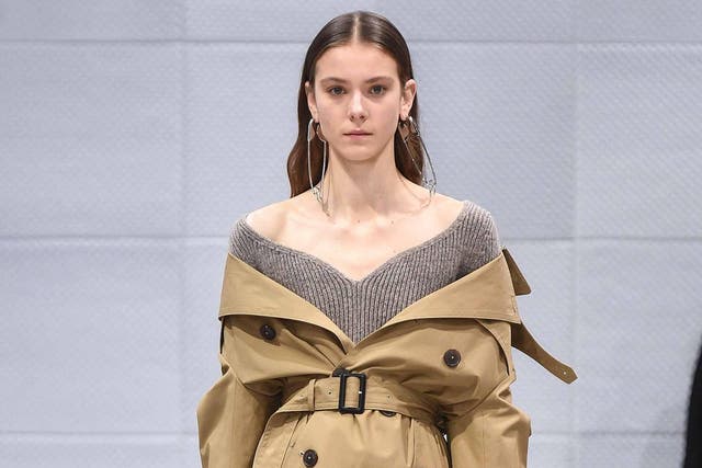 At Balenciaga the trench was worn off the shoulder and cinched at the waist