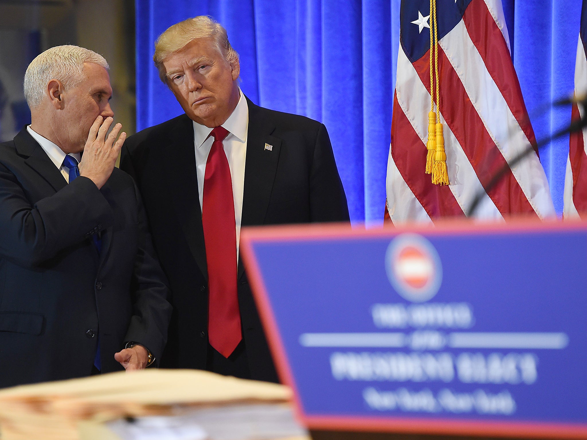 President-elect Donald Trump talks to Vice President-elect Mike Pence during a press conference at Trump Tower in New York