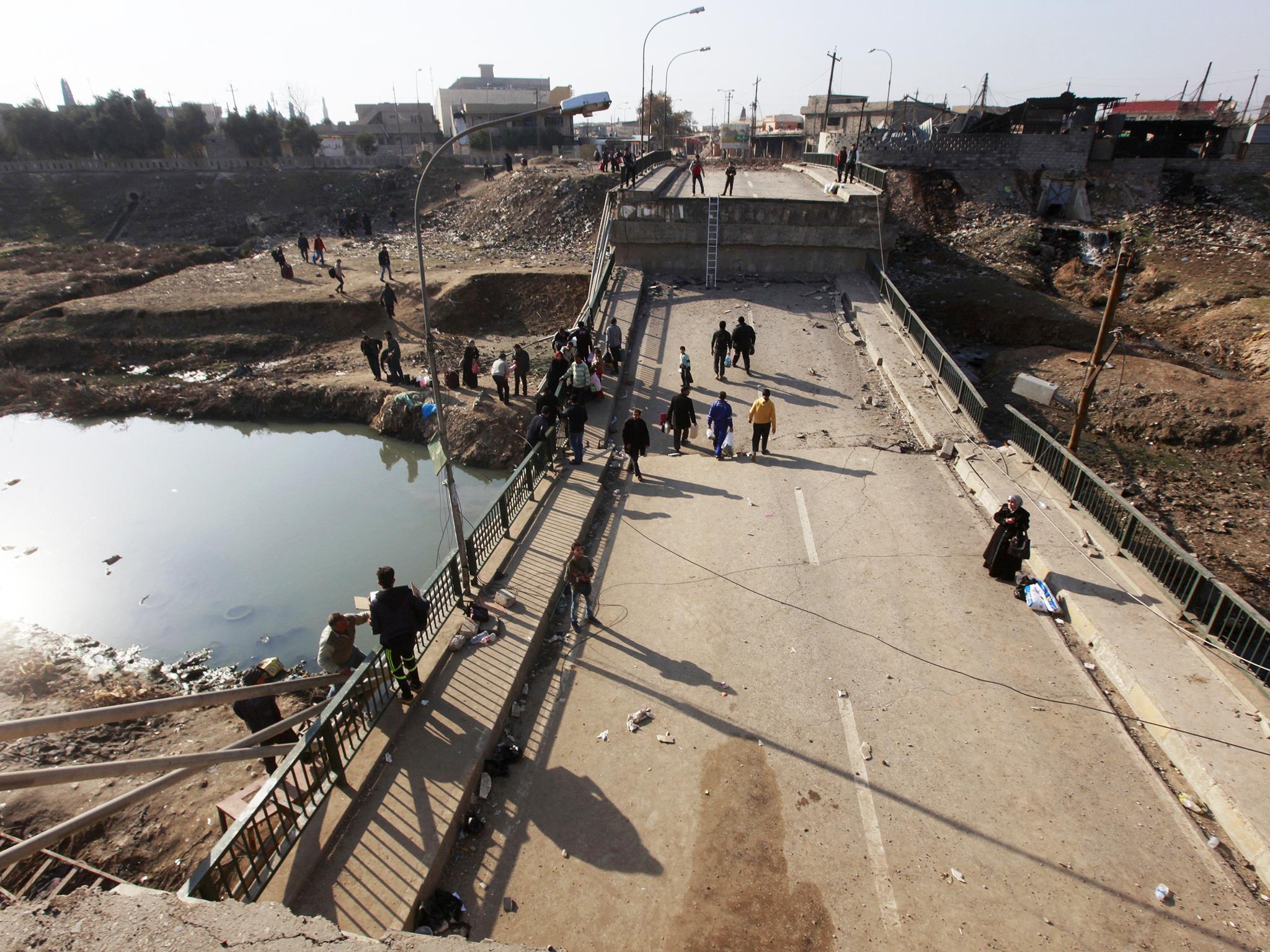 Despite being bombed the bridge still has foot traffic in both directions