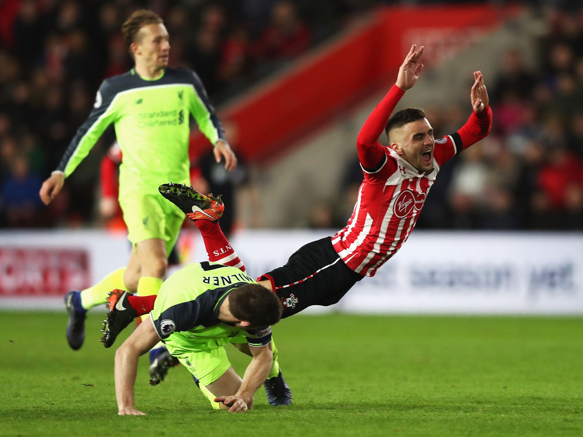 Dusan Tadic is brought down by James Milner