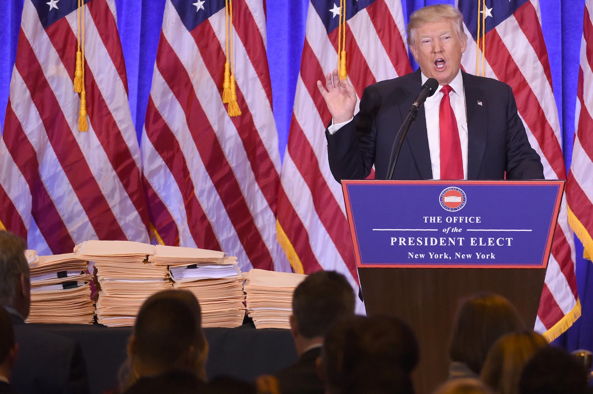 Numerous files are displayed as US President-elect Donald Trump gives a press conference January 11, 2017 in New York