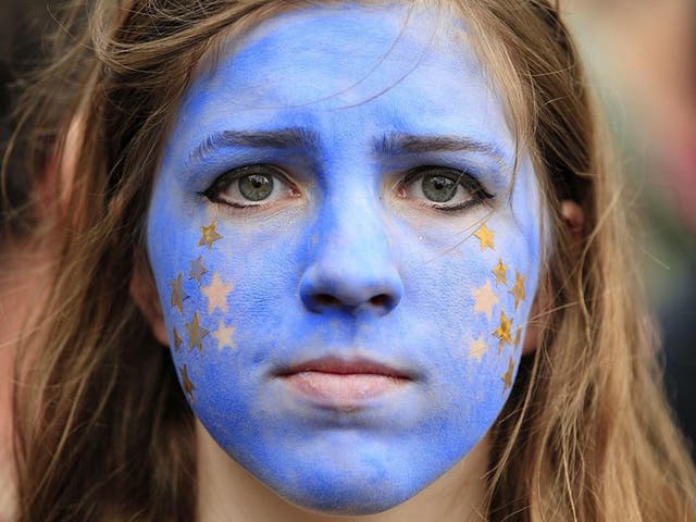 A "Remain" supporter, her face painted to resemble the EU flag, protests in London on July 2