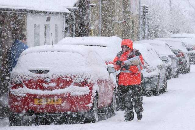 A postman braves the weather near Stirling, Scotland